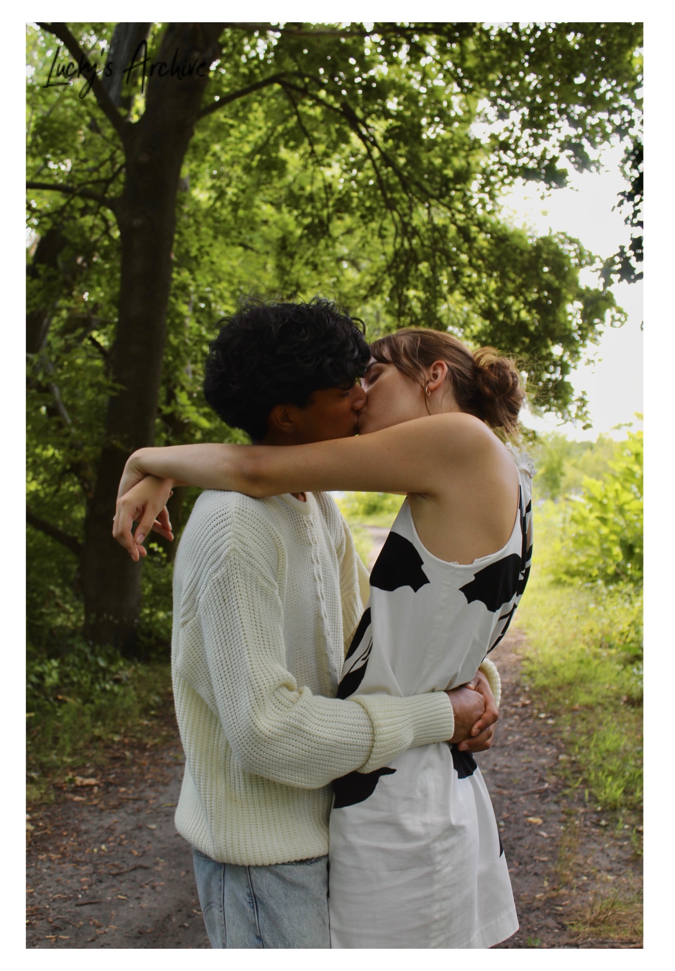 Couple kissing on a wooded path