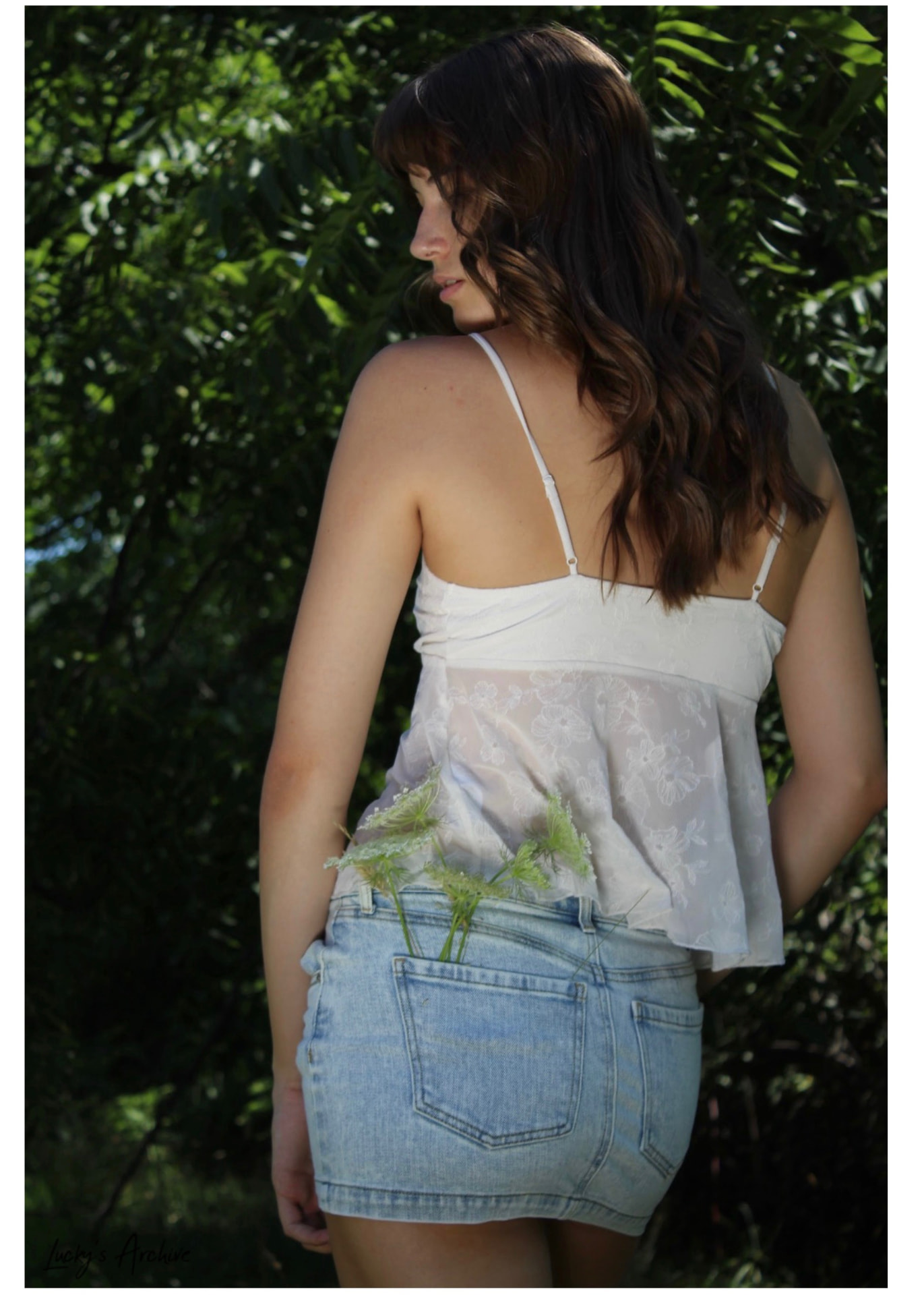 Portrait with wildflowers in a denim skirt