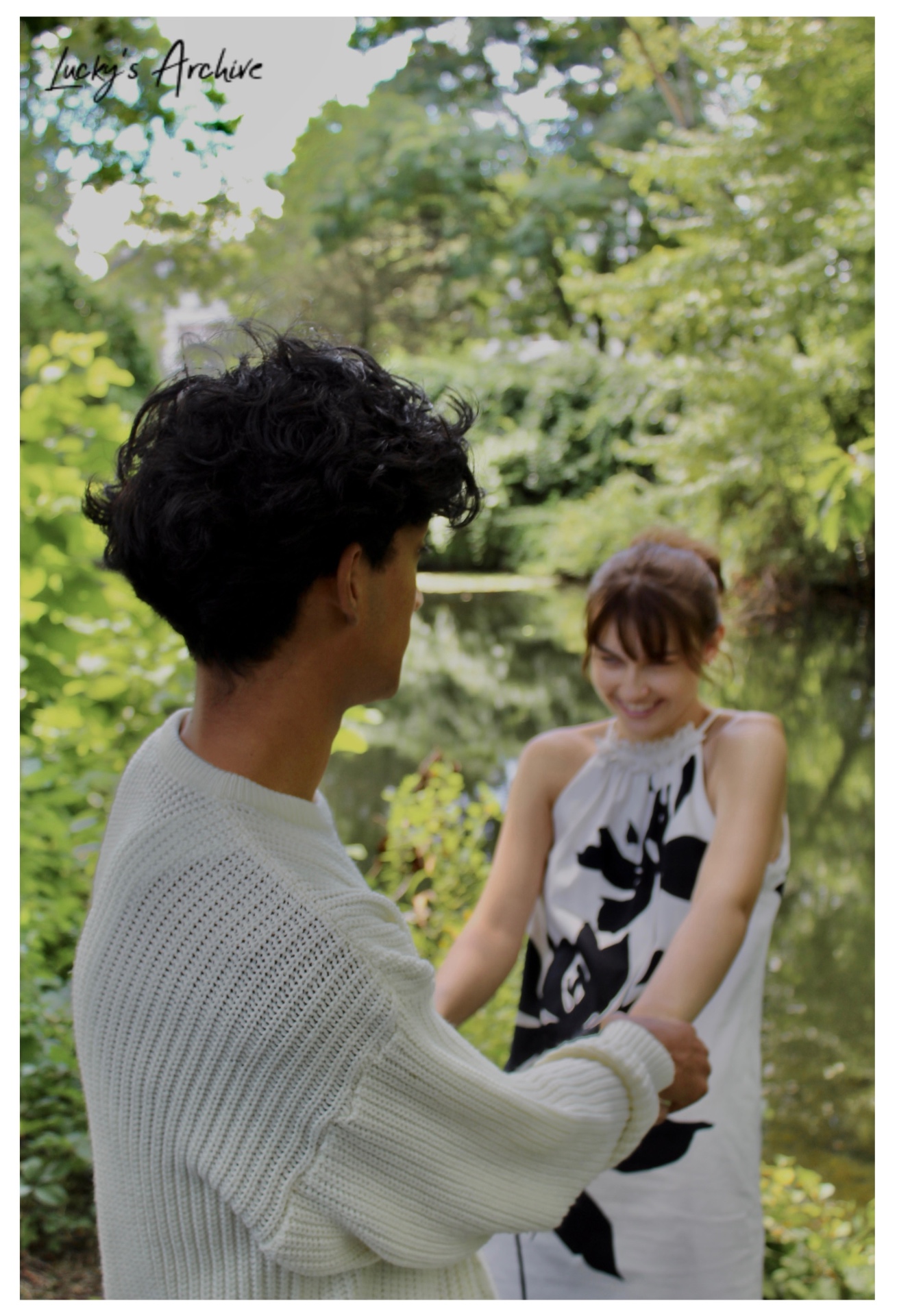 Candid couple moment beside the pond