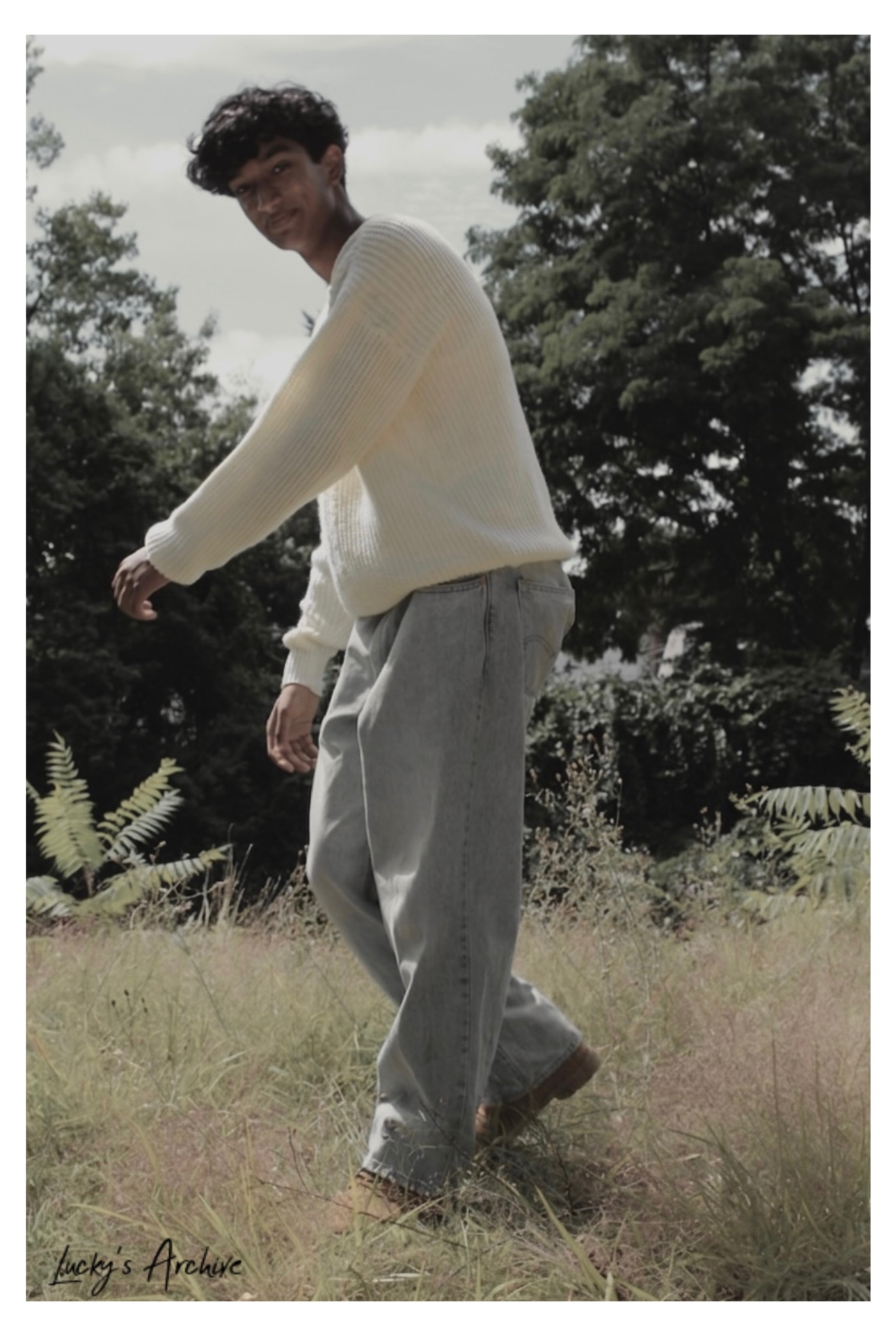 Walking portrait through tall grass in soft daylight