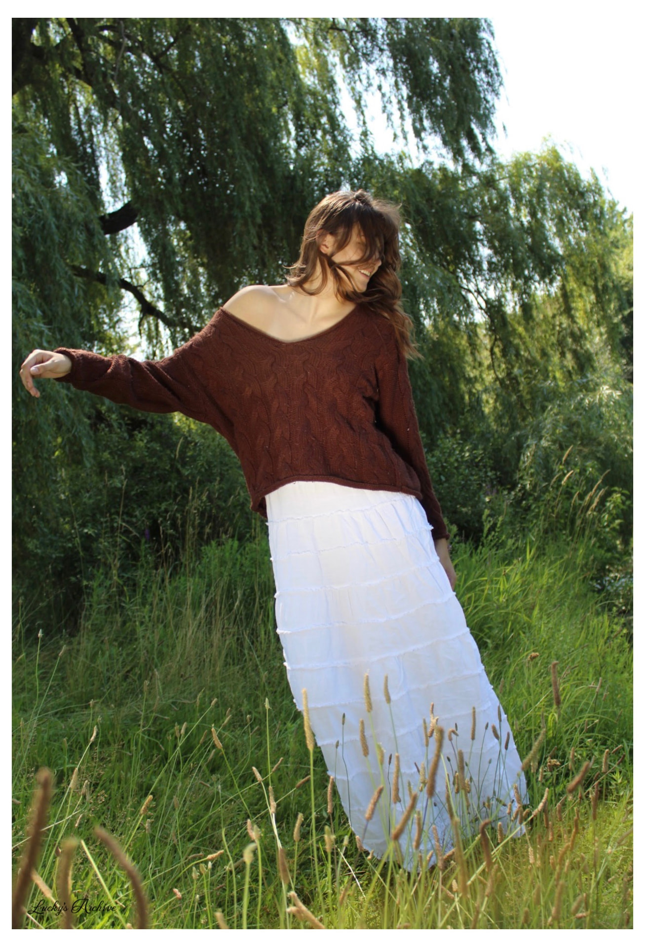 Movement portrait beneath a willow tree