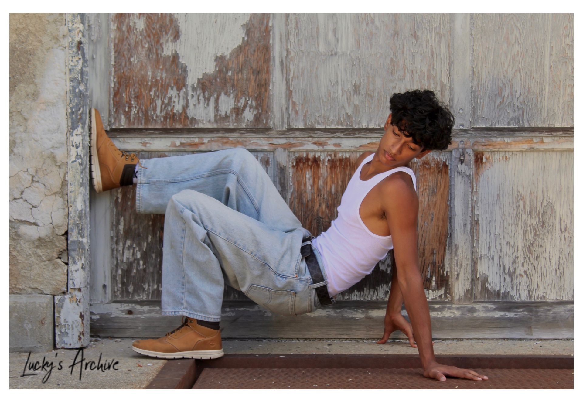 Athletic pose against a weathered wooden garage door