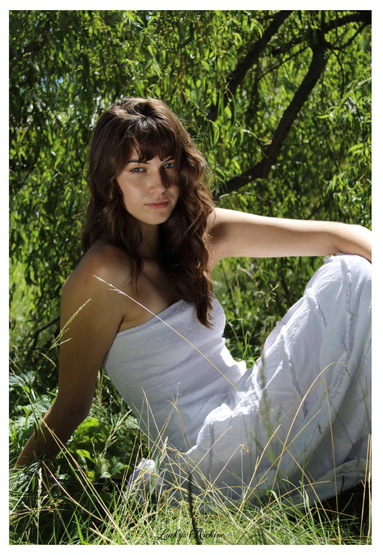 Natural light portrait in tall grass under a willow