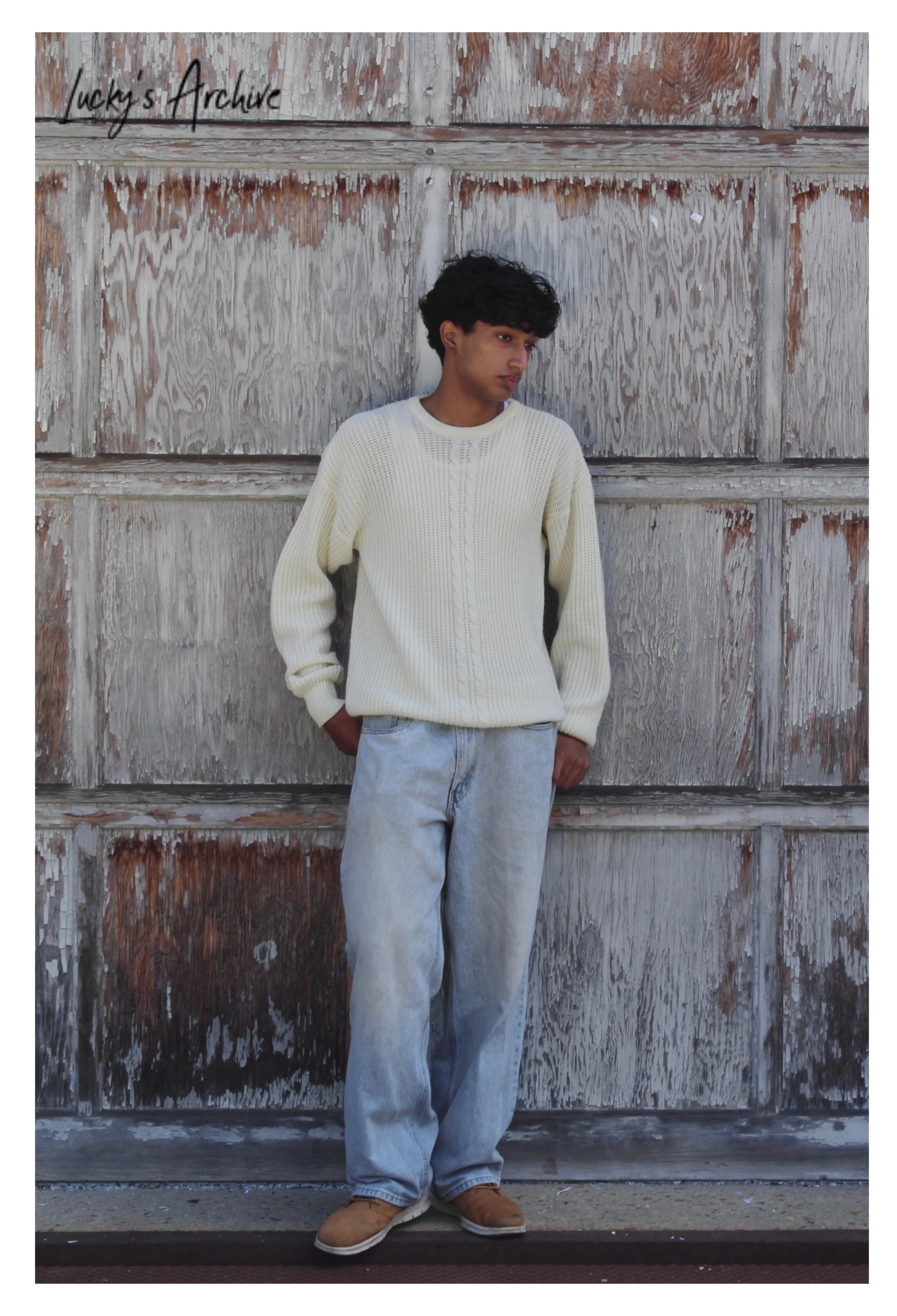 Full-length portrait in a cream sweater and light denim