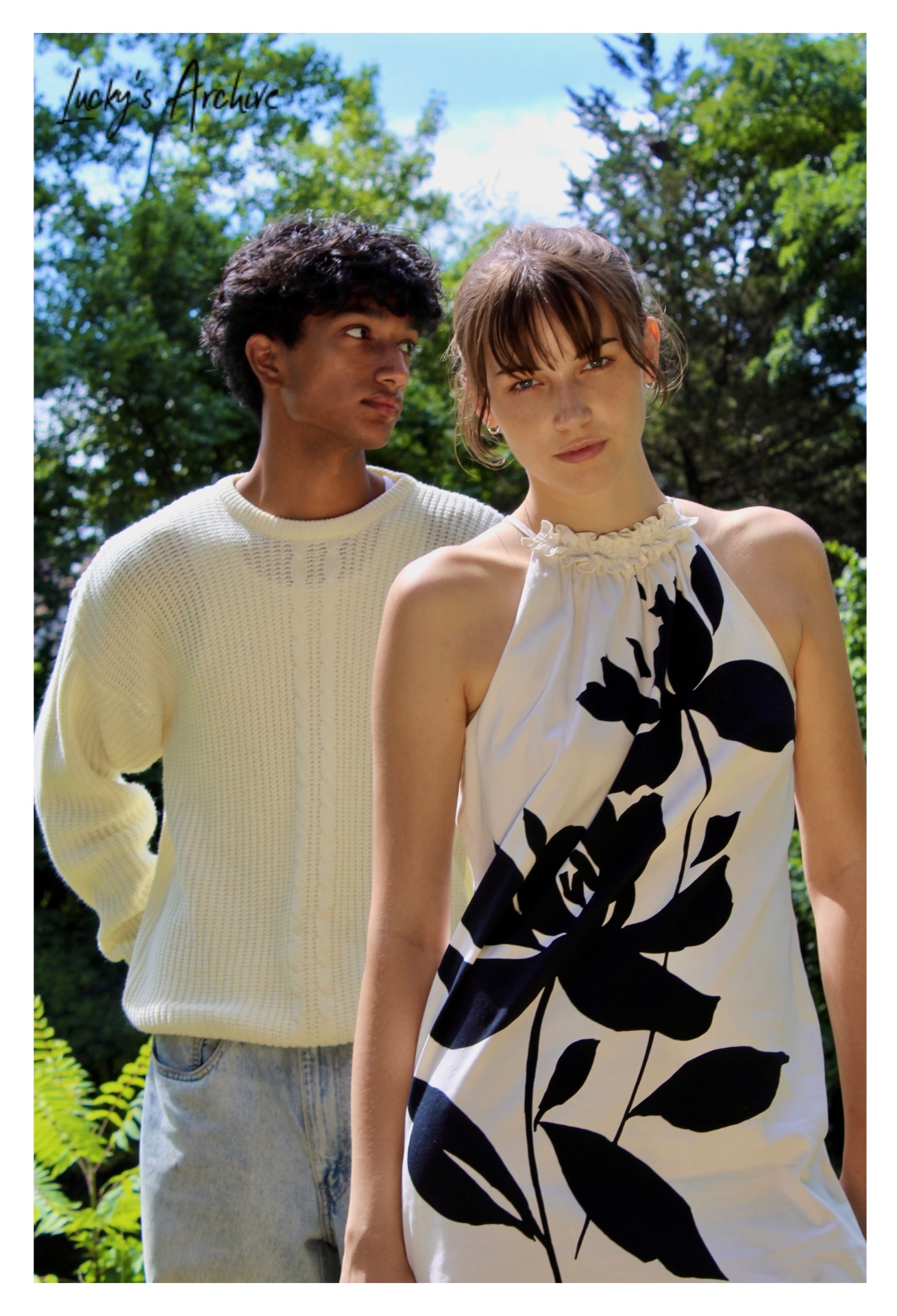 Couple standing close in dappled summer light