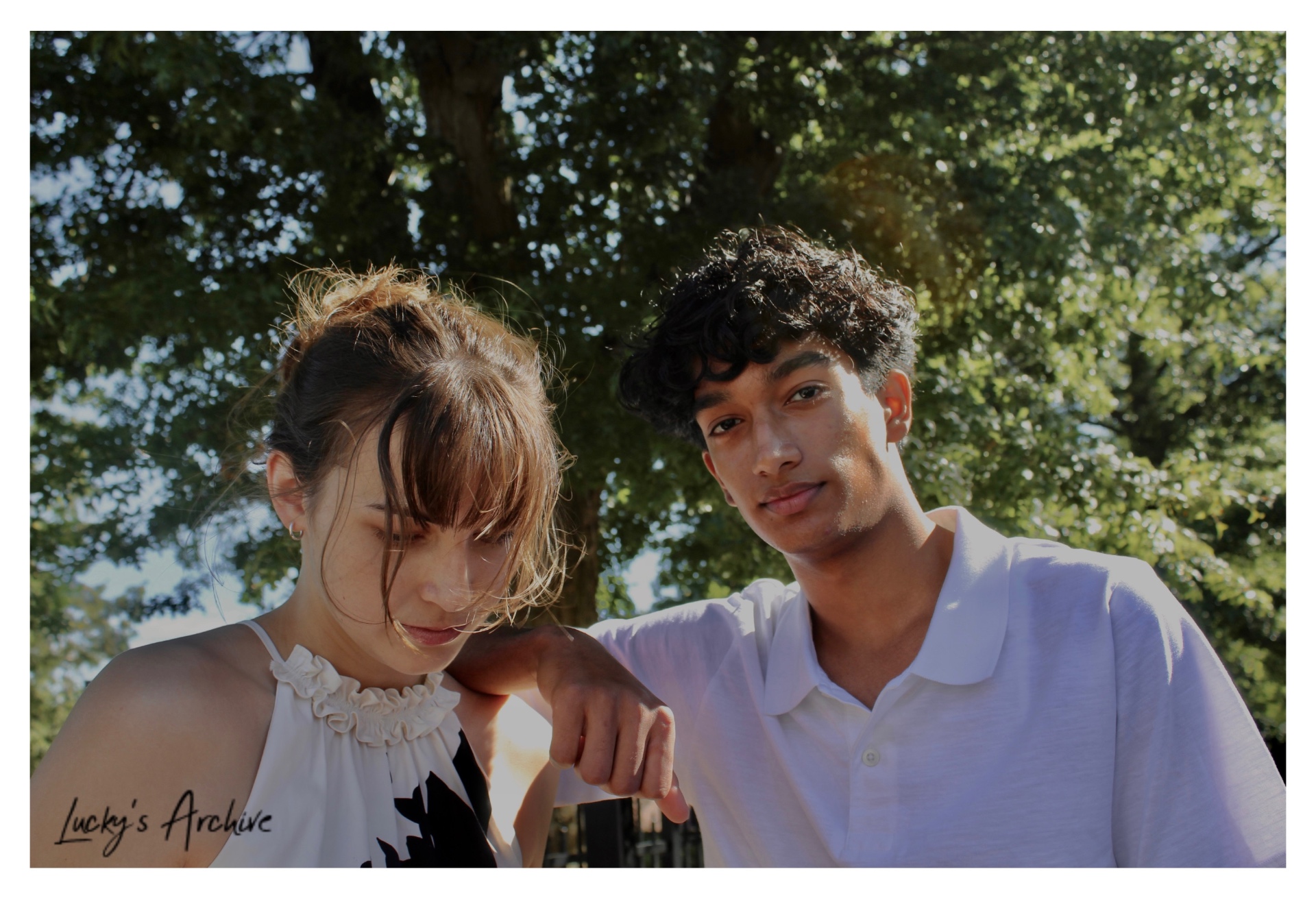 Candid couple portrait beneath a shade tree