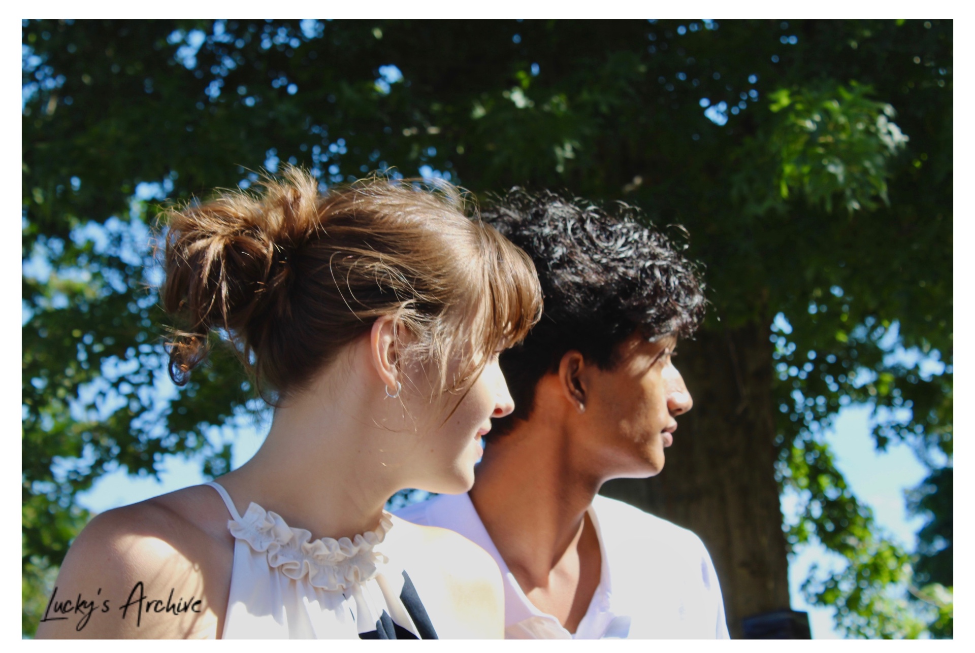 Side profile portrait of a couple in sunlight