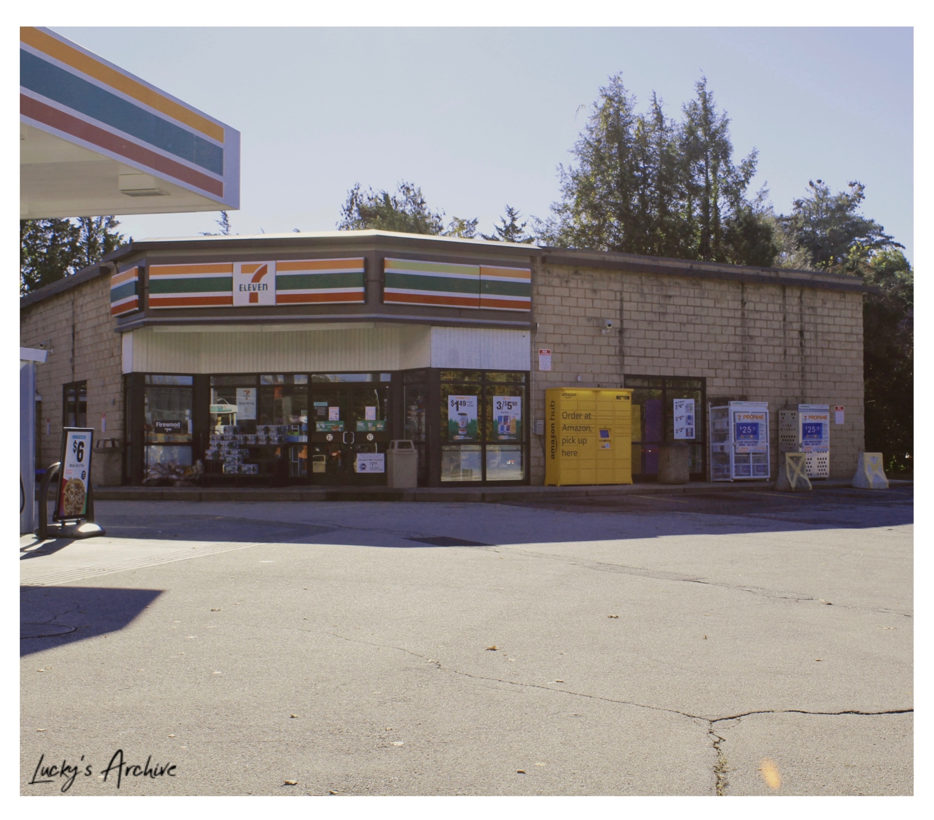 Sunlit 7-Eleven storefront and empty parking lot
