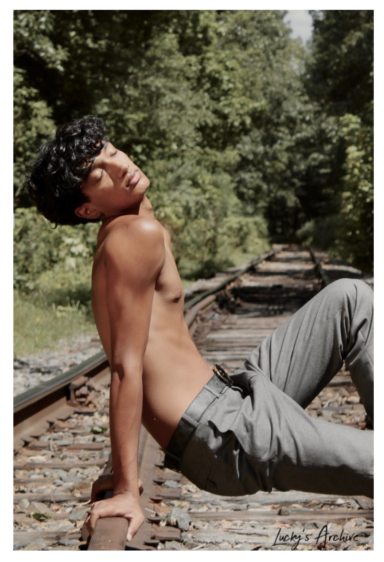 Editorial reclining pose on railroad tracks