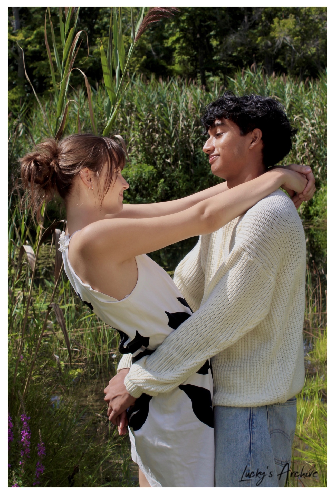 Couple embracing by the marsh reeds